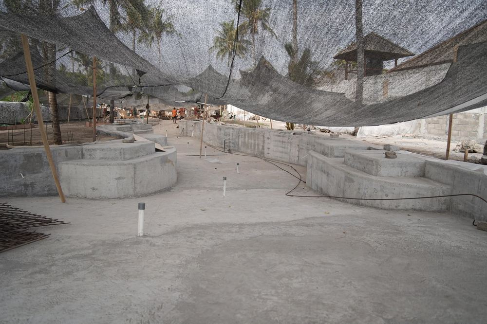 Aerial view of the Divino Beach Gili Air construction site, with the suites building taking shape among the palm trees
